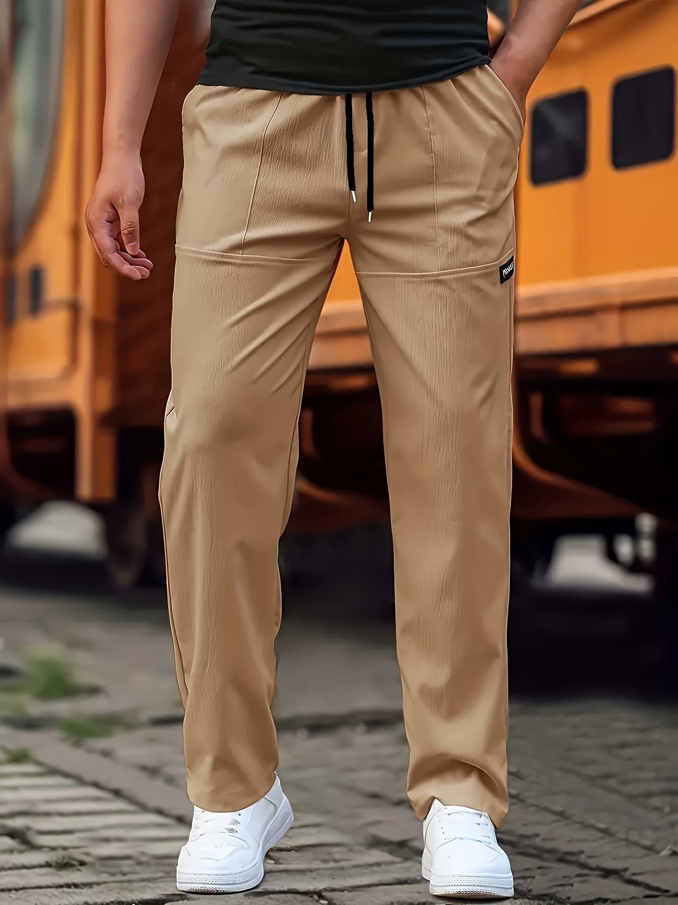 Person wearing beige pants with a blurred background