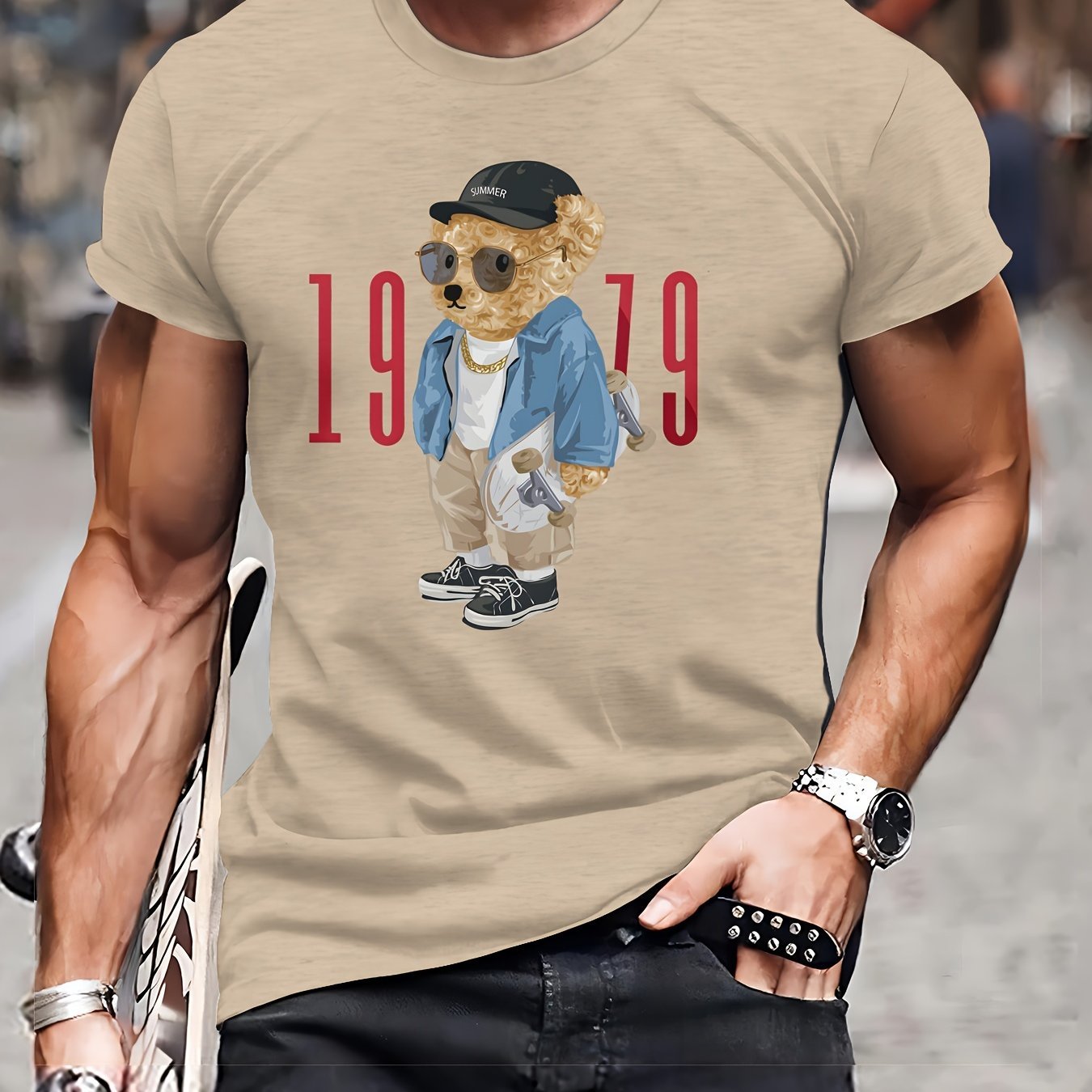 Beige t-shirt with a bear graphic and '1979' text worn by a person.