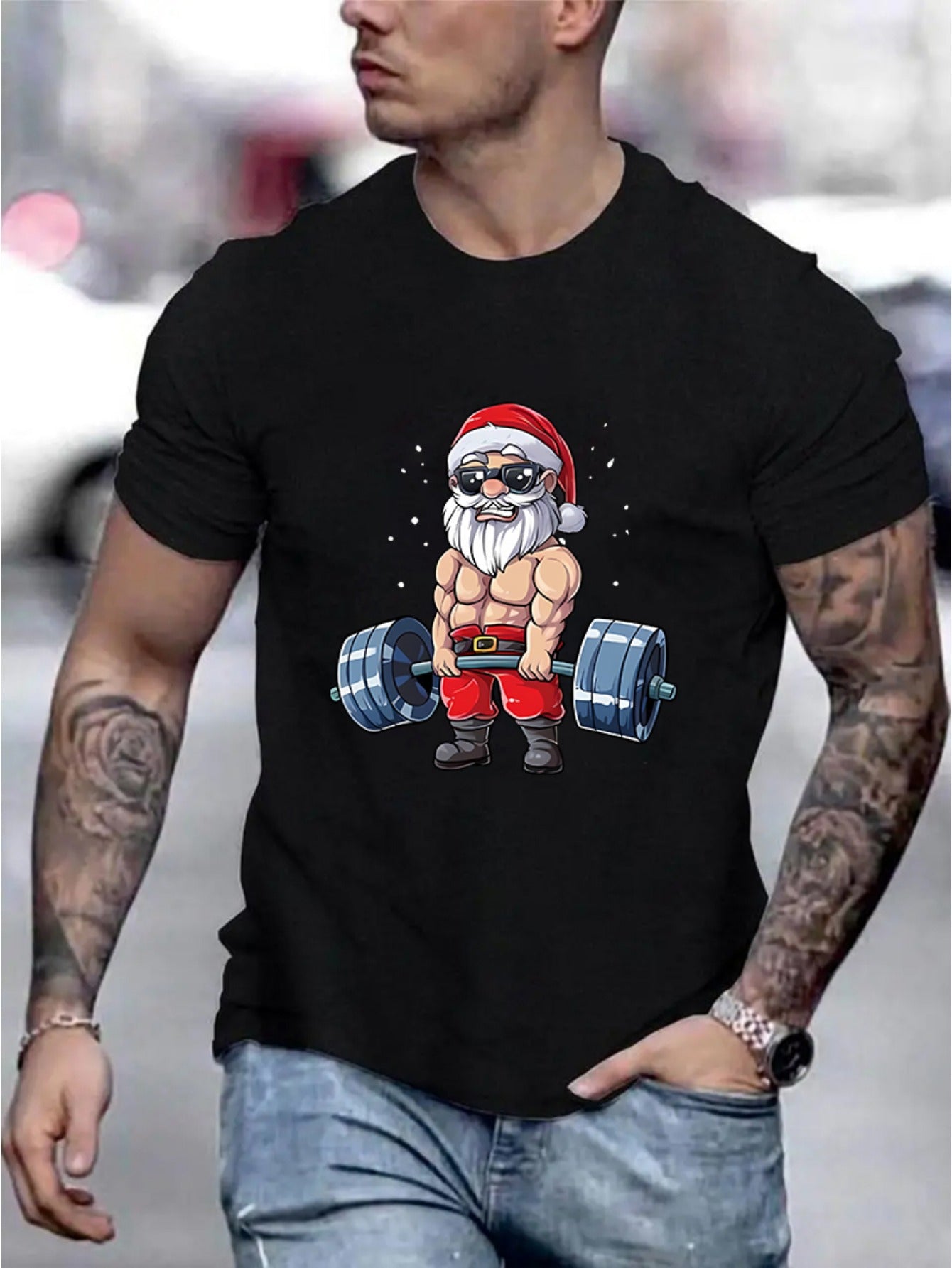 Person wearing a black t-shirt with a graphic of Santa Claus lifting weights.