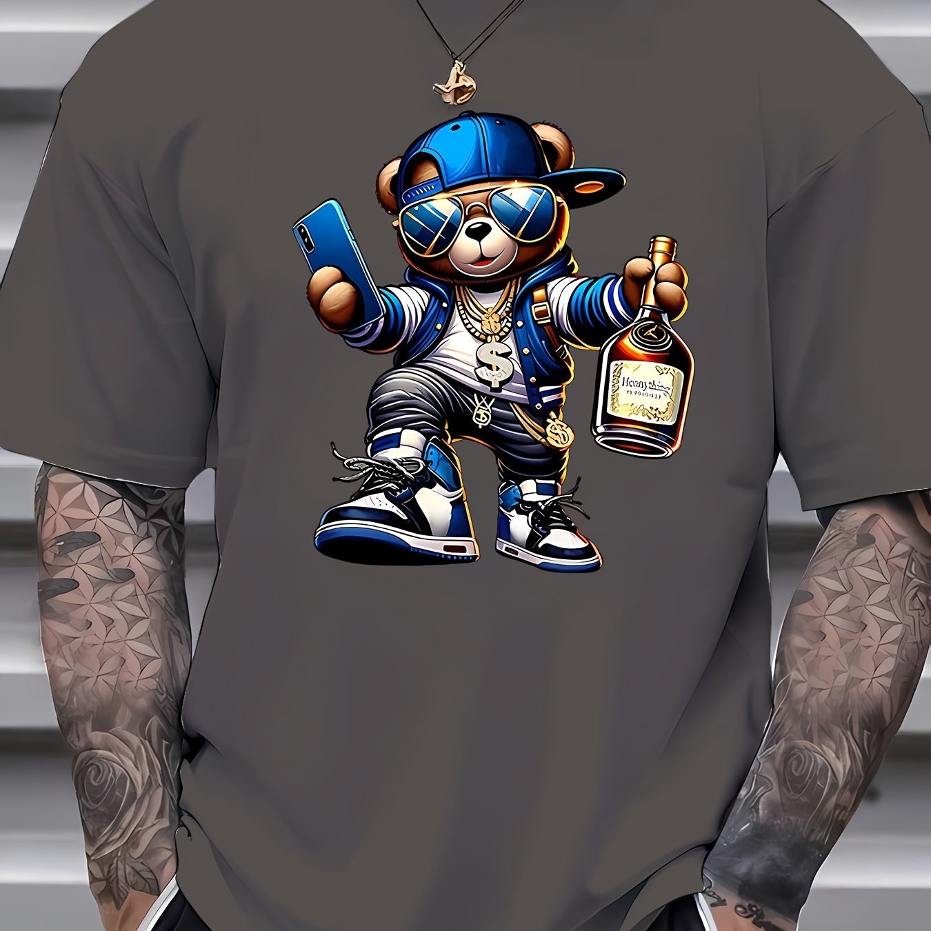 Gray t-shirt with a cartoon bear holding a phone and bottle on a gray background