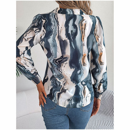 Marbled patterned blouse worn by a person on a neutral background