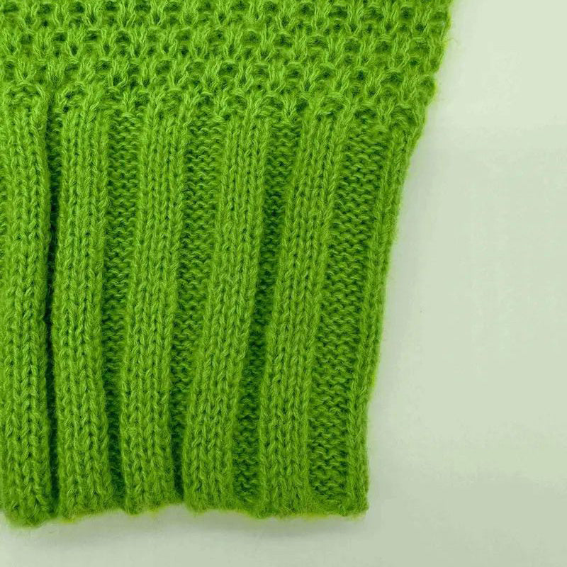 Close-up of a green knitted fabric on a white background