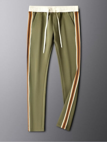 Green pants with side stripes on a gray background
