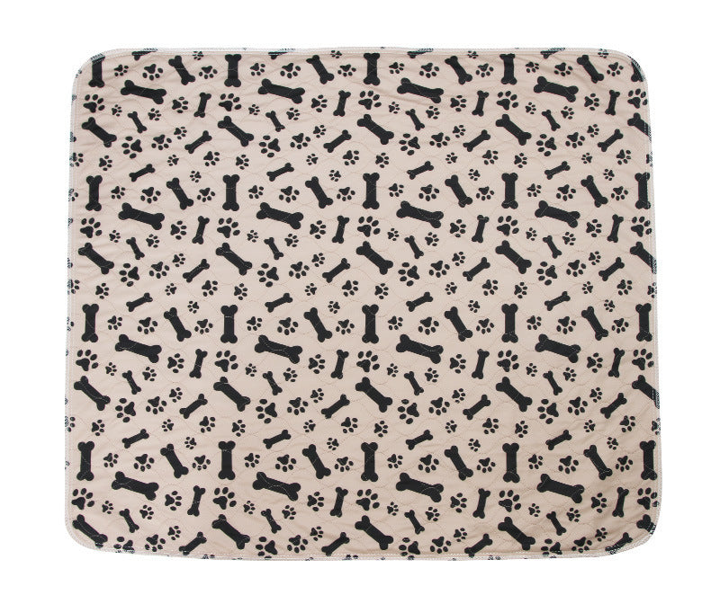 Patterned mat with black bones and paw prints on a beige background