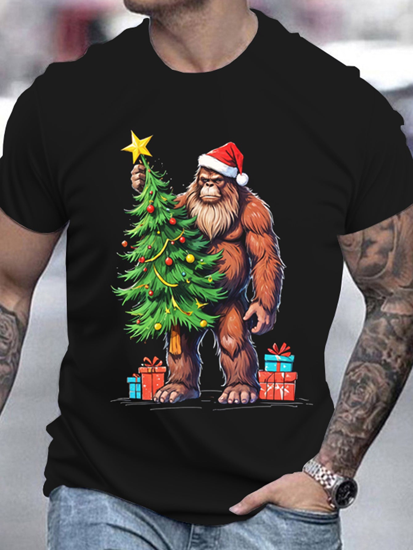 Black t-shirt with a Christmas-themed design featuring a bear holding a tree and presents, worn by a person.