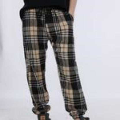 Plaid pants worn by a person on a white background