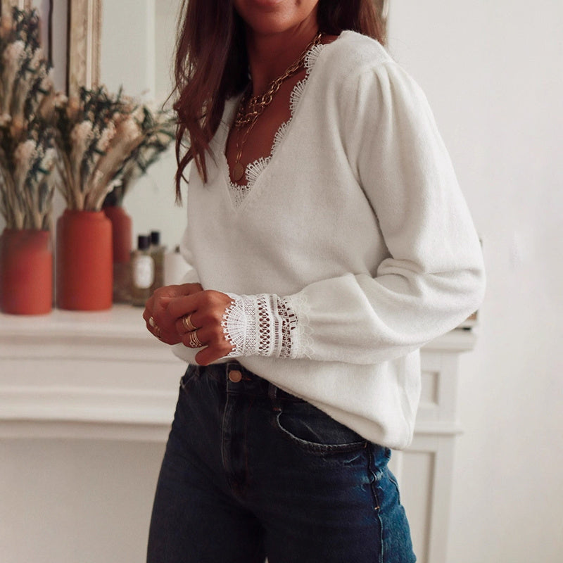 Person wearing a white sweater with lace details in a home setting