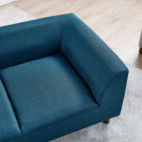 Blue sofa corner on a light wooden floor