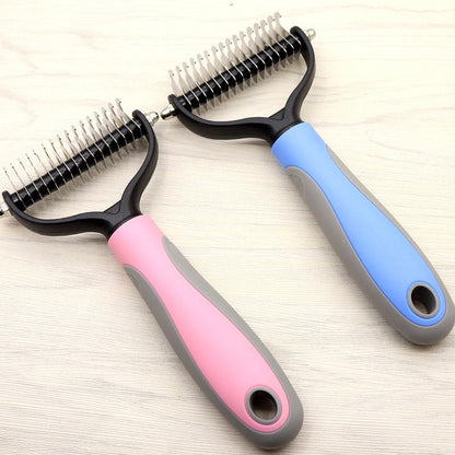 Two pet grooming tools with pink and blue handles on a light wooden surface.