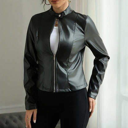 Person wearing a black leather jacket indoors with a neutral background