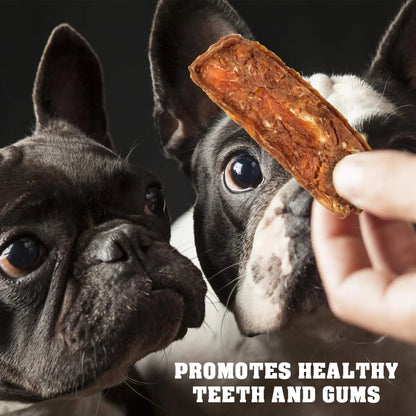 Two dogs eagerly looking at a dog treat held by a hand with text promoting dental health.