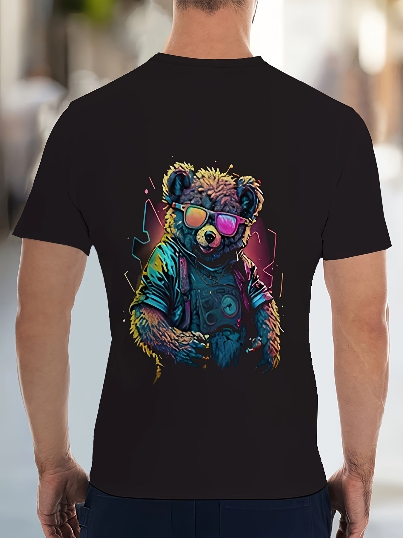 Black t-shirt with a colorful bear graphic and sunglasses on a blurred street background