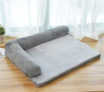 Gray pet bed with rolled-up side on a wooden floor