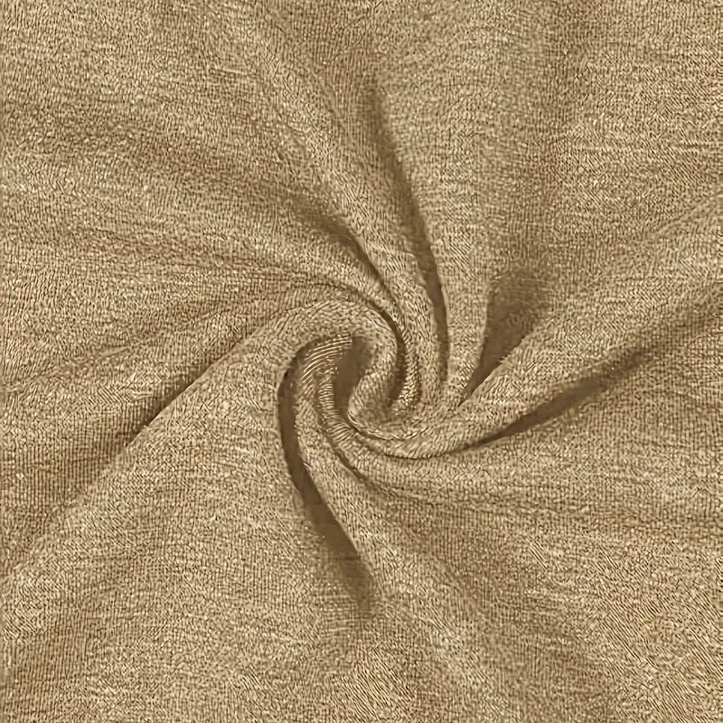 Close-up of beige fabric with a swirl pattern