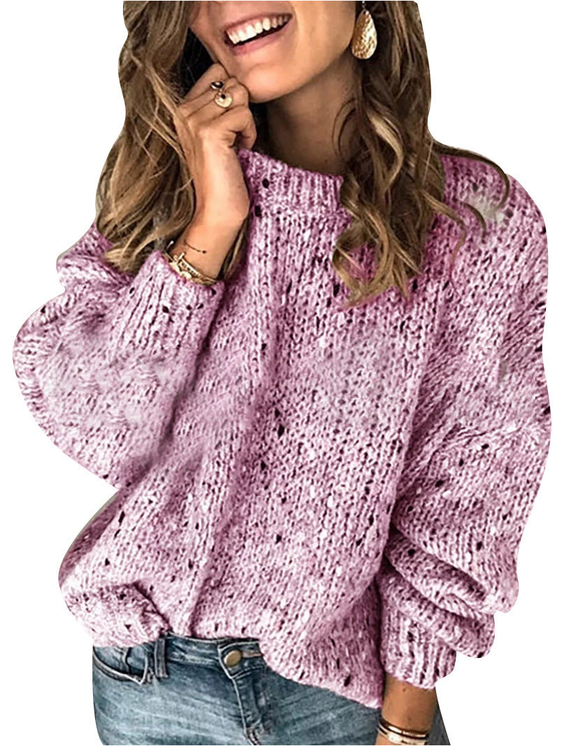 Woman wearing a pink knitted sweater with a blurred background