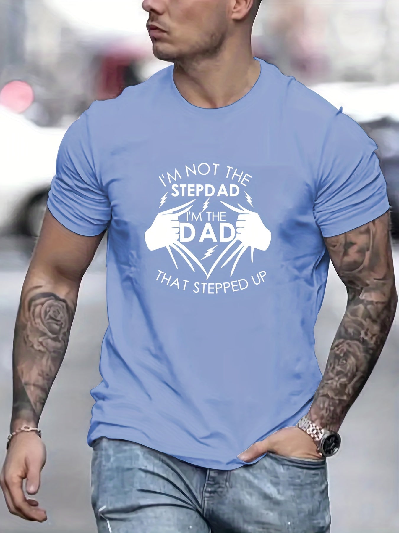 Man wearing a blue t-shirt with a humorous graphic and text.