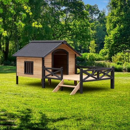 Wooden doghouse with a small deck on a grassy area with trees in the background