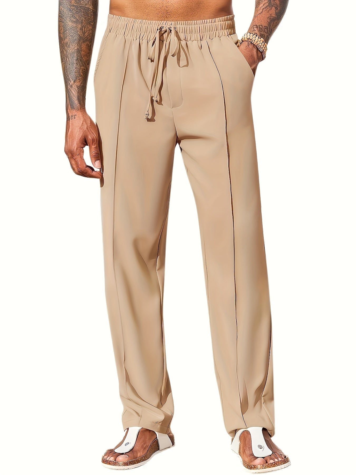 Beige drawstring pants worn by a person on a white background