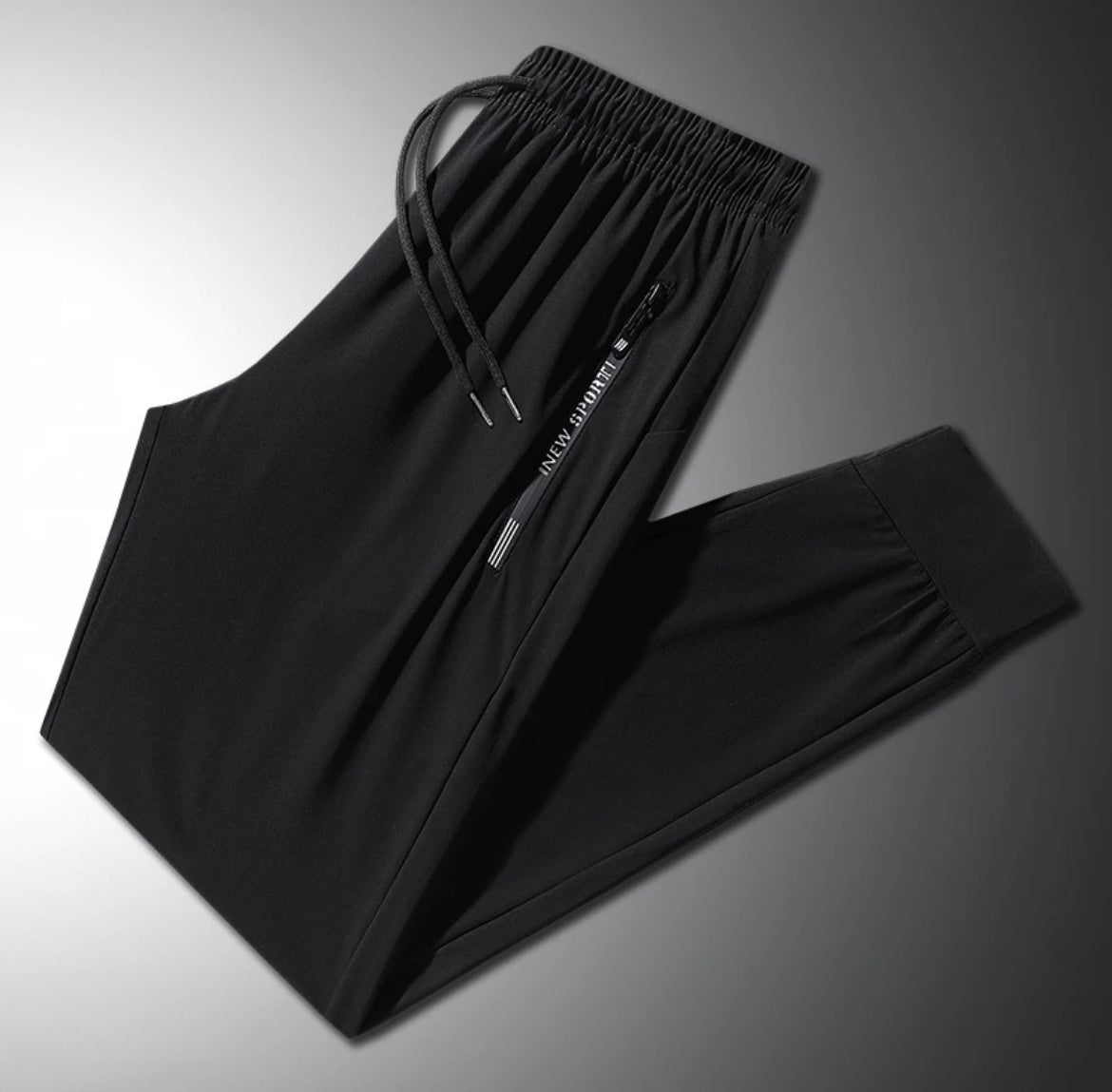Black pants with a brand logo on a gradient background