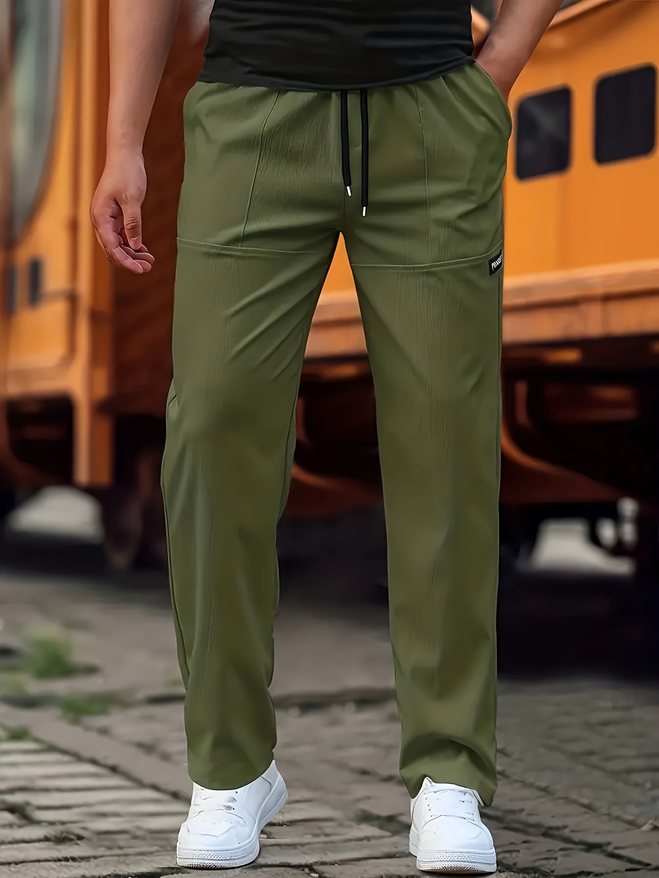 Person wearing green pants with a blurred background