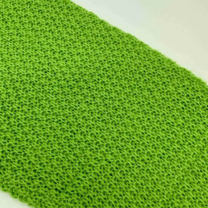 Green textured fabric on a white background