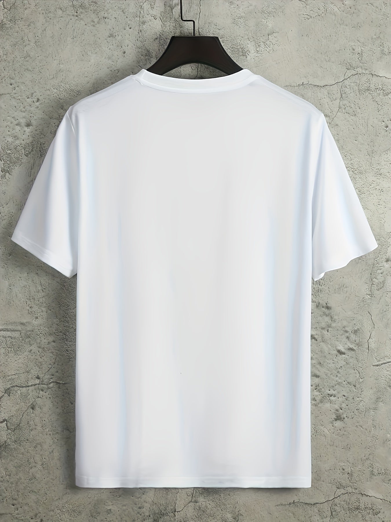 White t-shirt on a hanger against a concrete wall