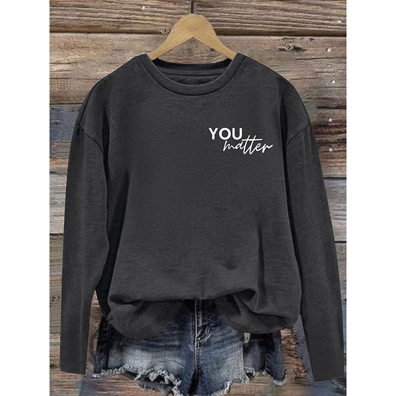 Dark gray sweatshirt with 'YOU matter' text on a wooden background