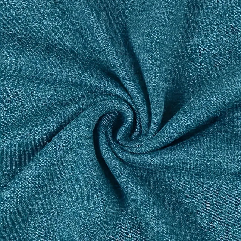 Close-up of teal fabric with a swirl pattern