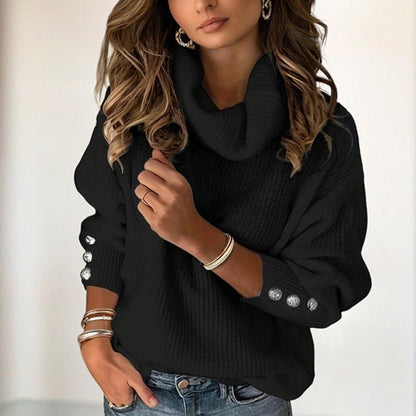 Woman wearing a black sweater with button details on a blurred background