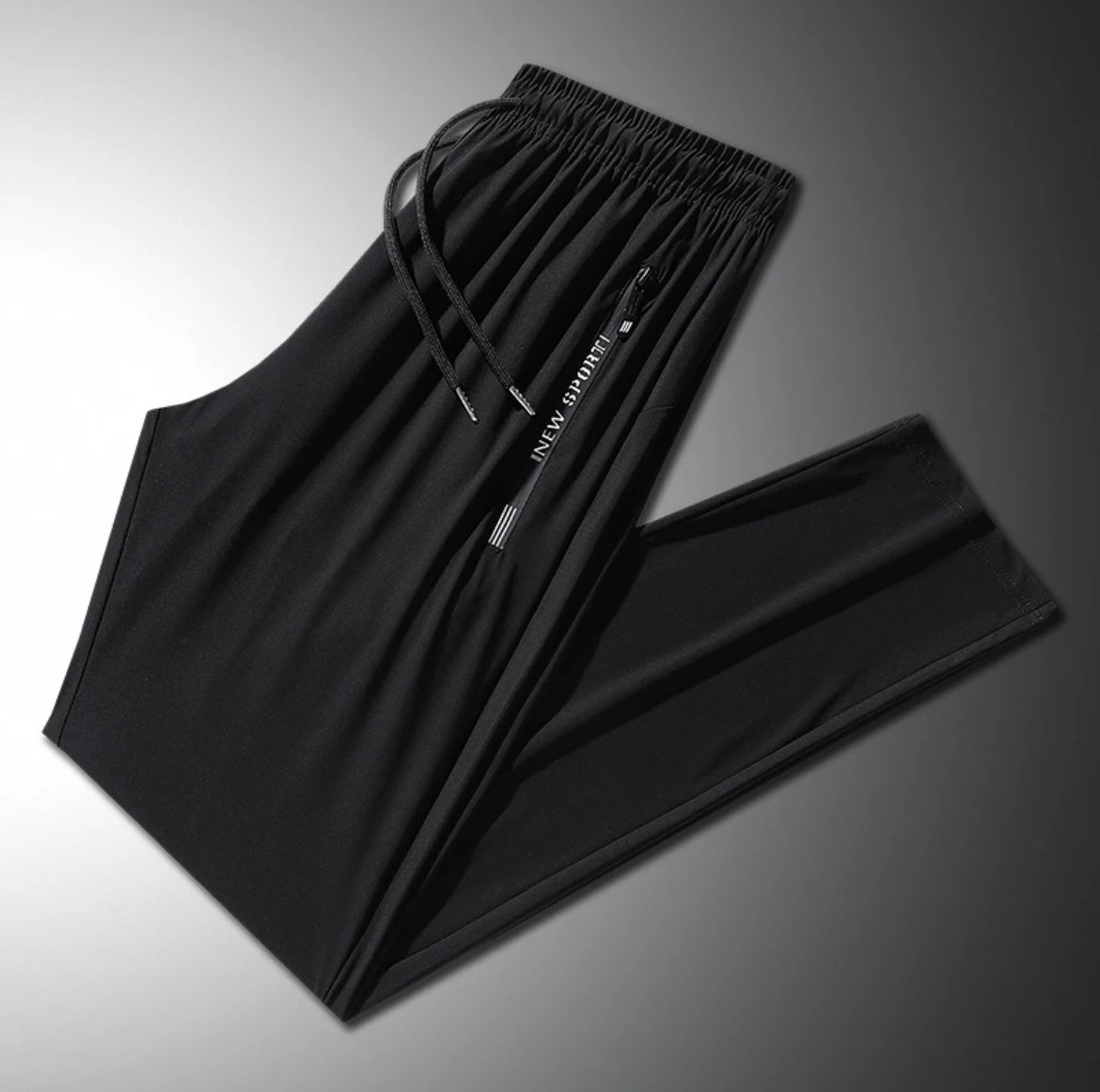 Black pants with drawstring on a gradient gray background