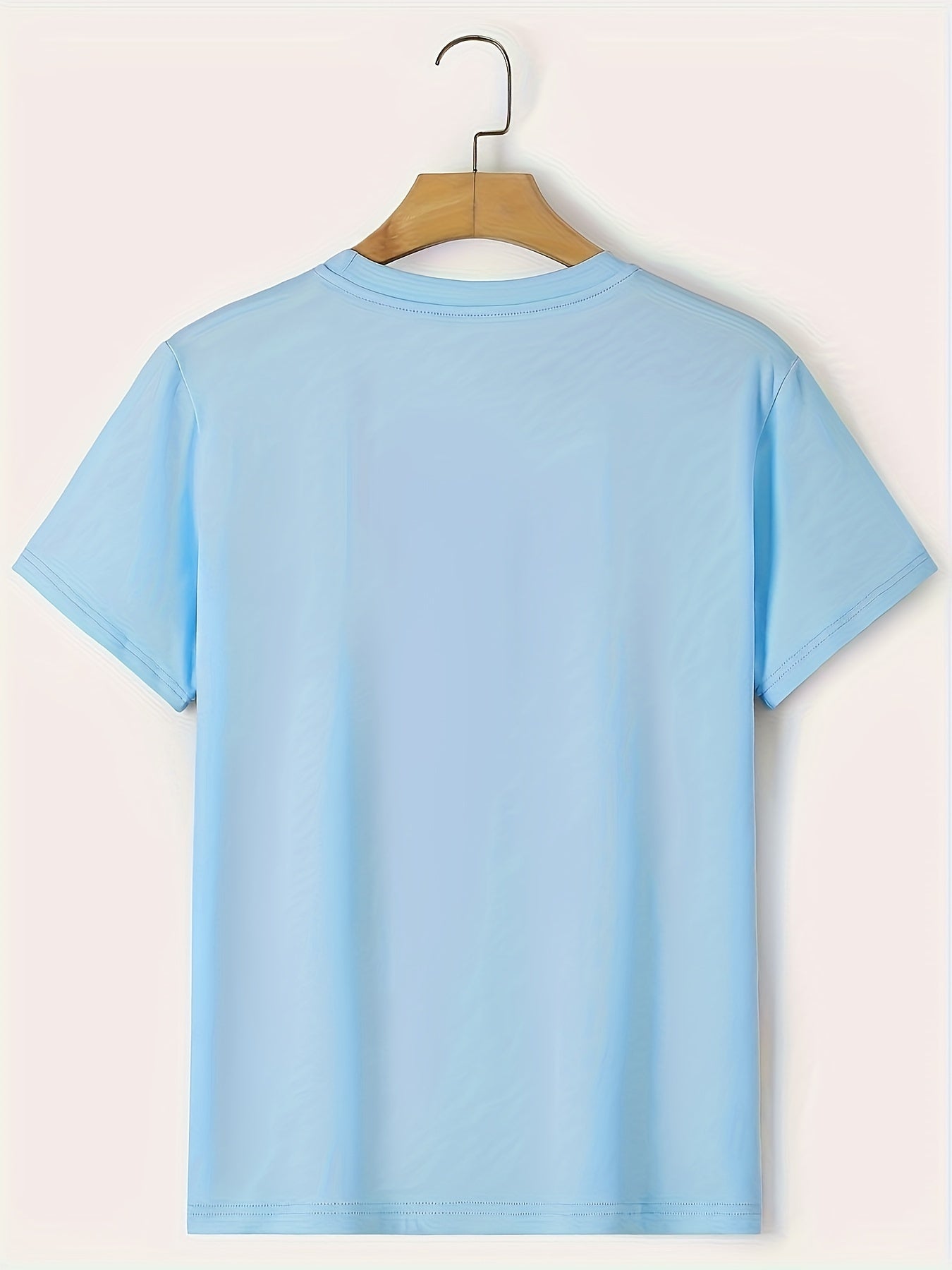 Light blue t-shirt on a hanger against a light background