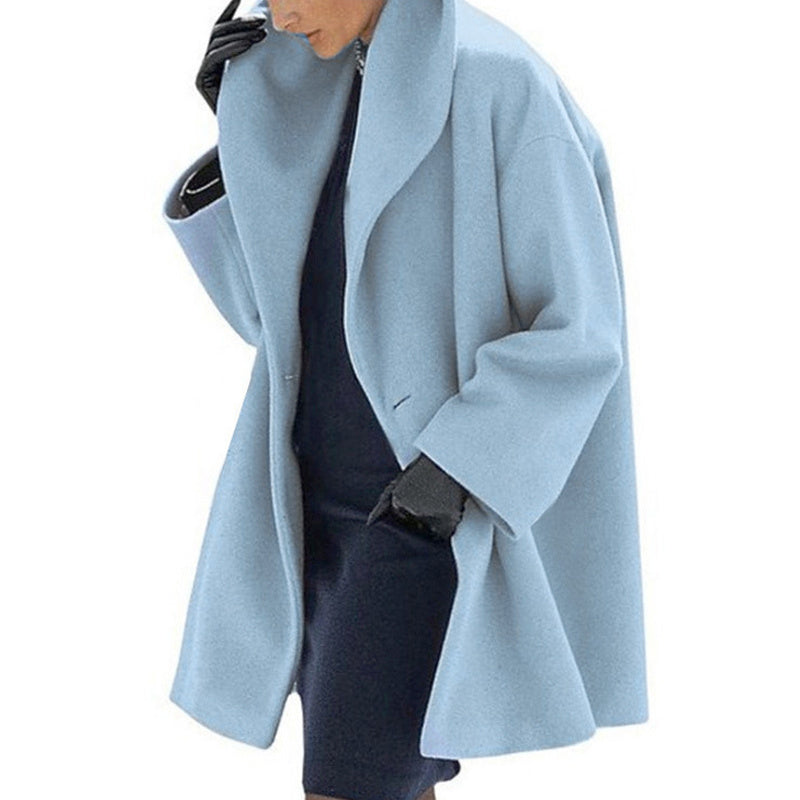 Light blue coat worn by a person on a white background