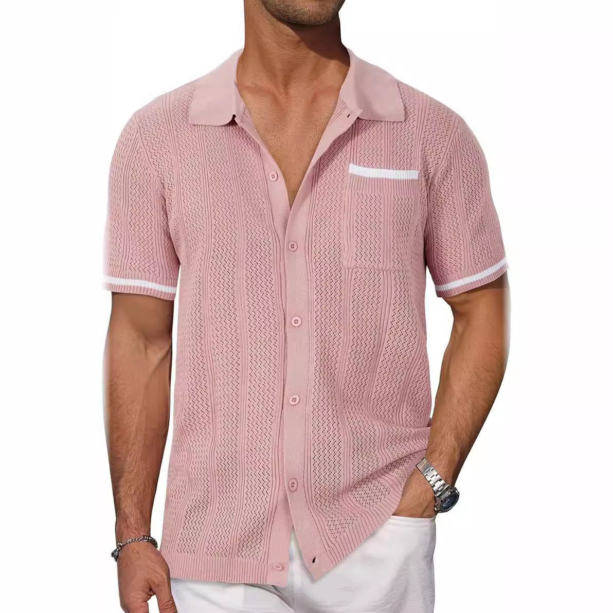 Man wearing a pink knitted shirt with white pants on a white background