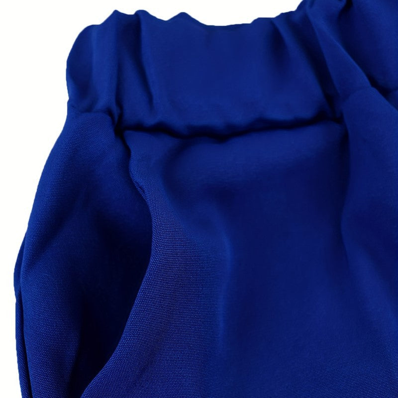 Close-up of a blue fabric with ruffled details on a white background