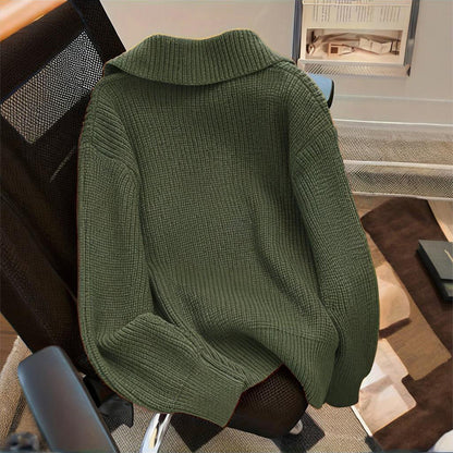 Green sweater draped over a chair in an indoor setting