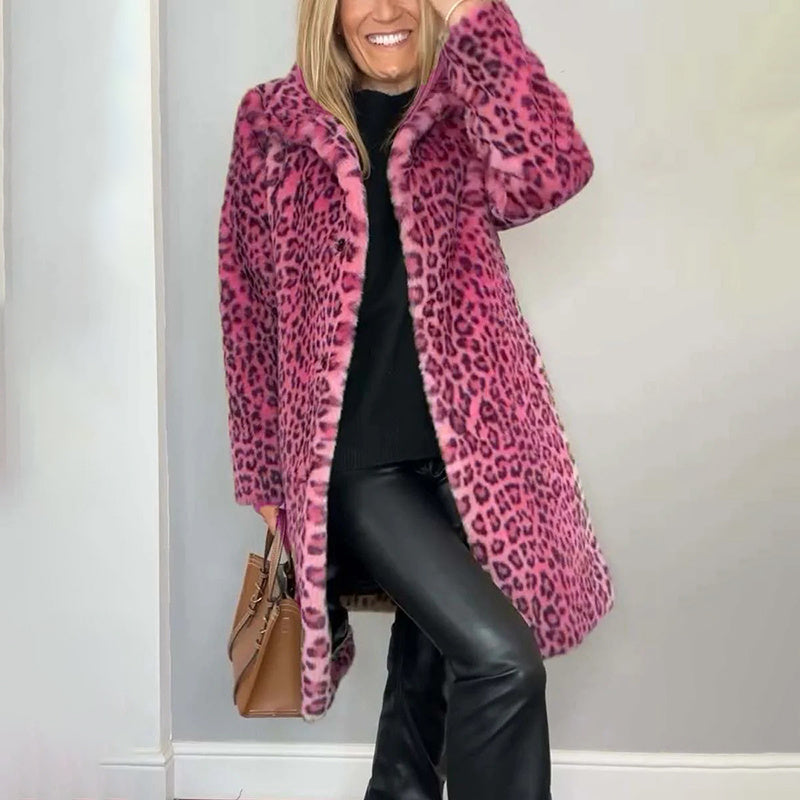 Person wearing a pink leopard print coat against a plain background
