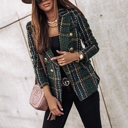 Woman wearing a green plaid blazer with a pink handbag against a neutral background