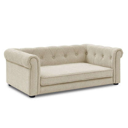Beige sofa with tufted backrest on a white background