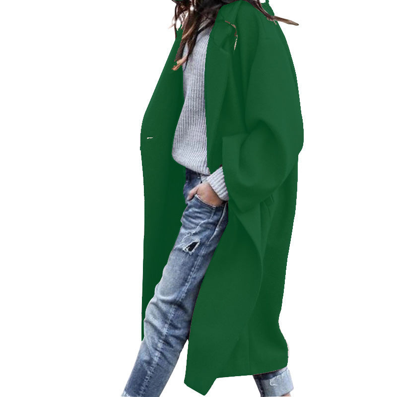 Green cardigan worn by a person on a white background