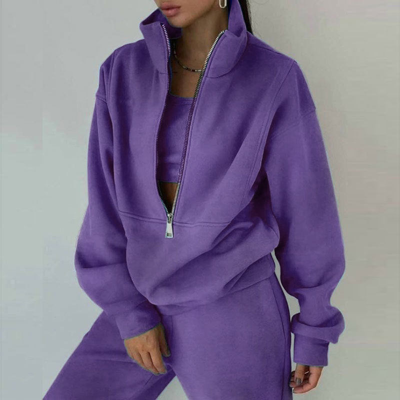 Person wearing a purple tracksuit against a plain background