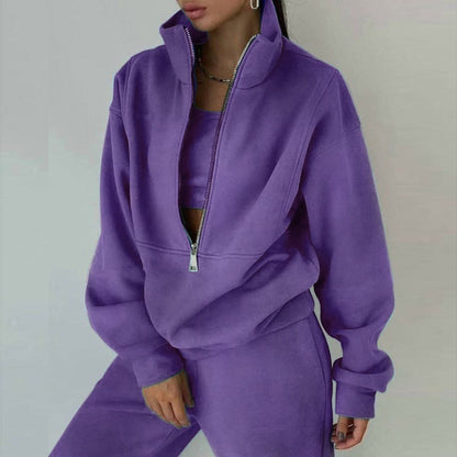 Person wearing a purple tracksuit against a plain background