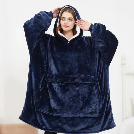 Person wearing a navy blue hooded blanket against a white background