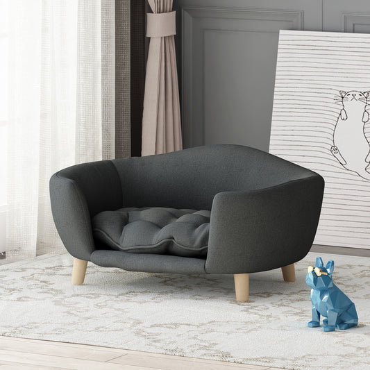 Gray pet sofa in a room with a blue statue and white wall.