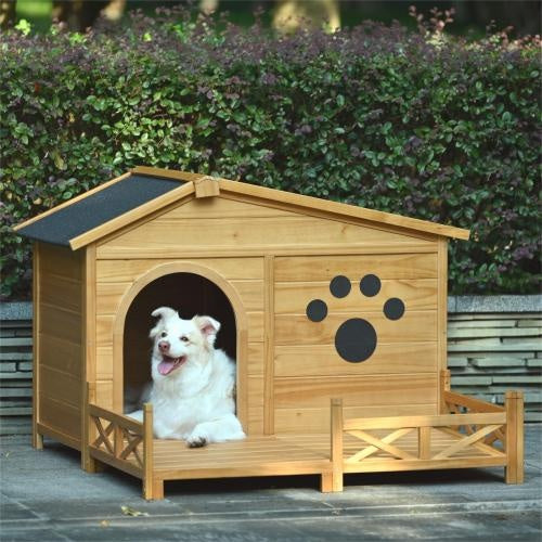 Wooden doghouse with a white dog inside, set against a green hedge background.