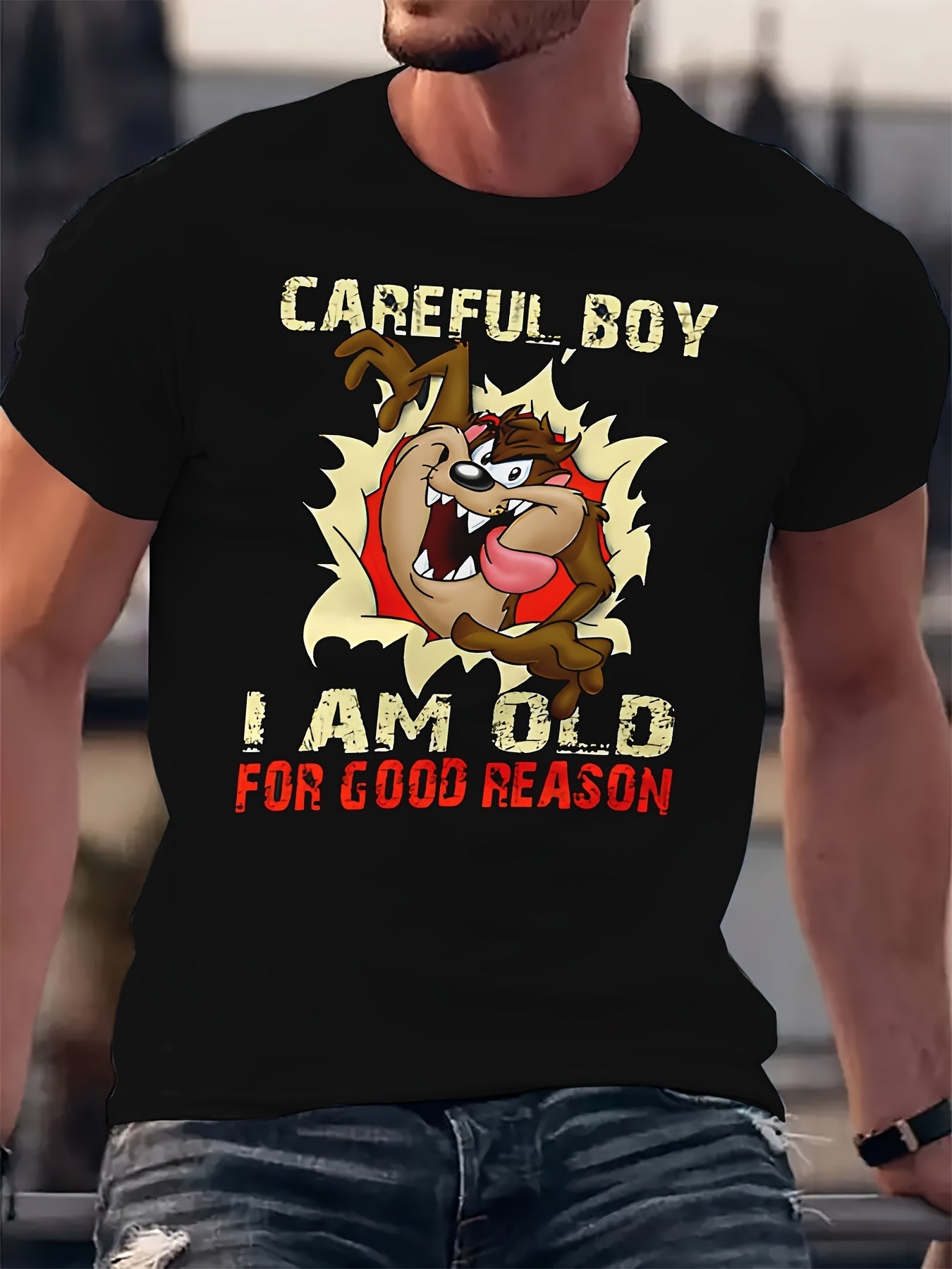 Person wearing a black t-shirt with a graphic design and text.