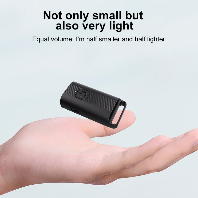Small black device held in a hand with text highlighting its size and weight.