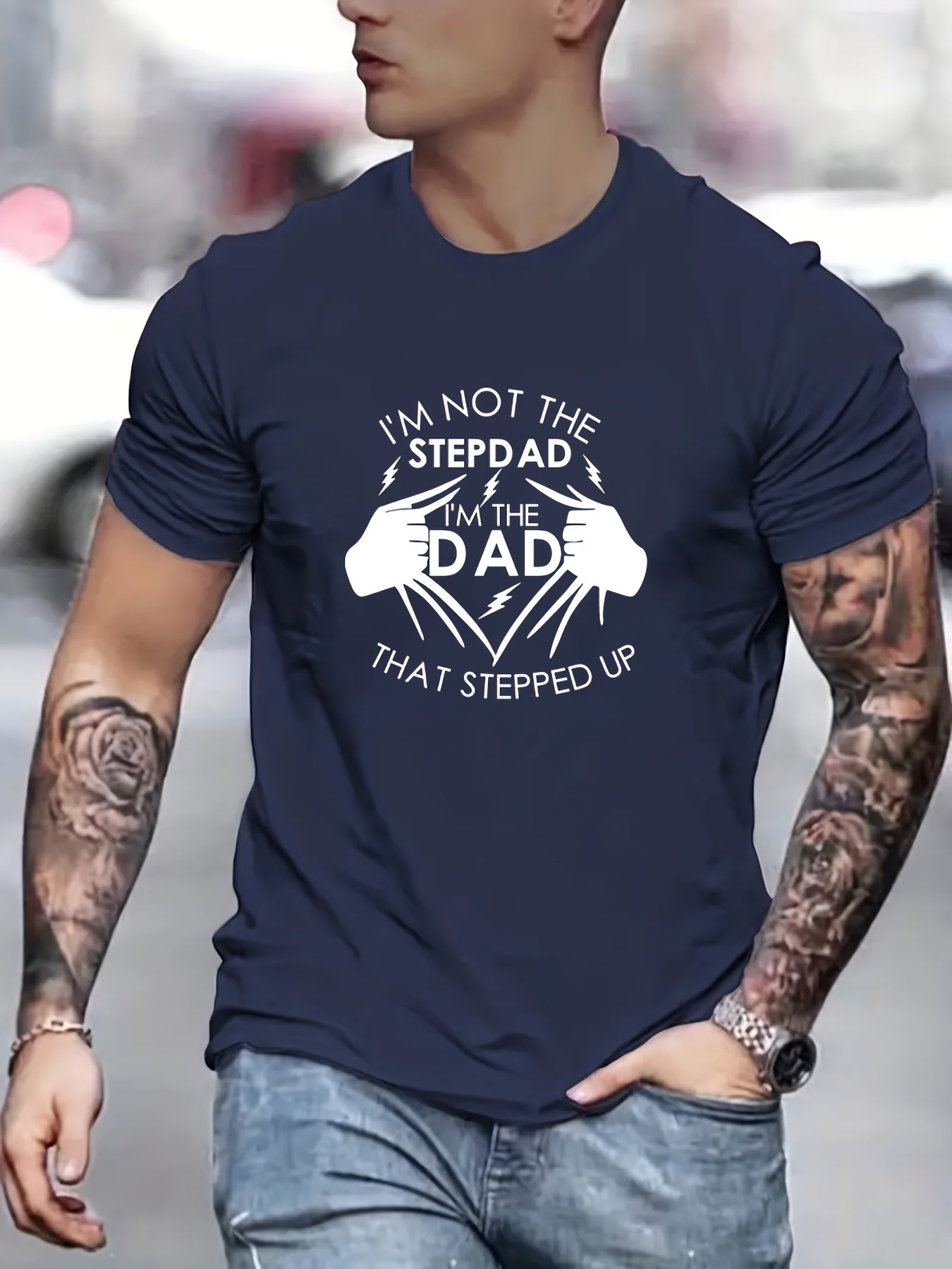 Person wearing a navy blue t-shirt with a humorous graphic and text.