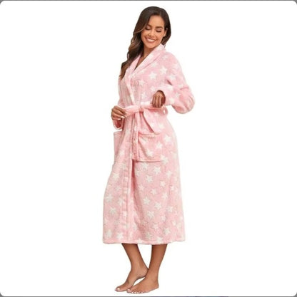 Woman wearing a pink robe with white floral patterns on a white background