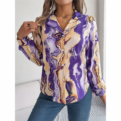 Woman wearing a long-sleeve shirt with a purple and gold abstract pattern.