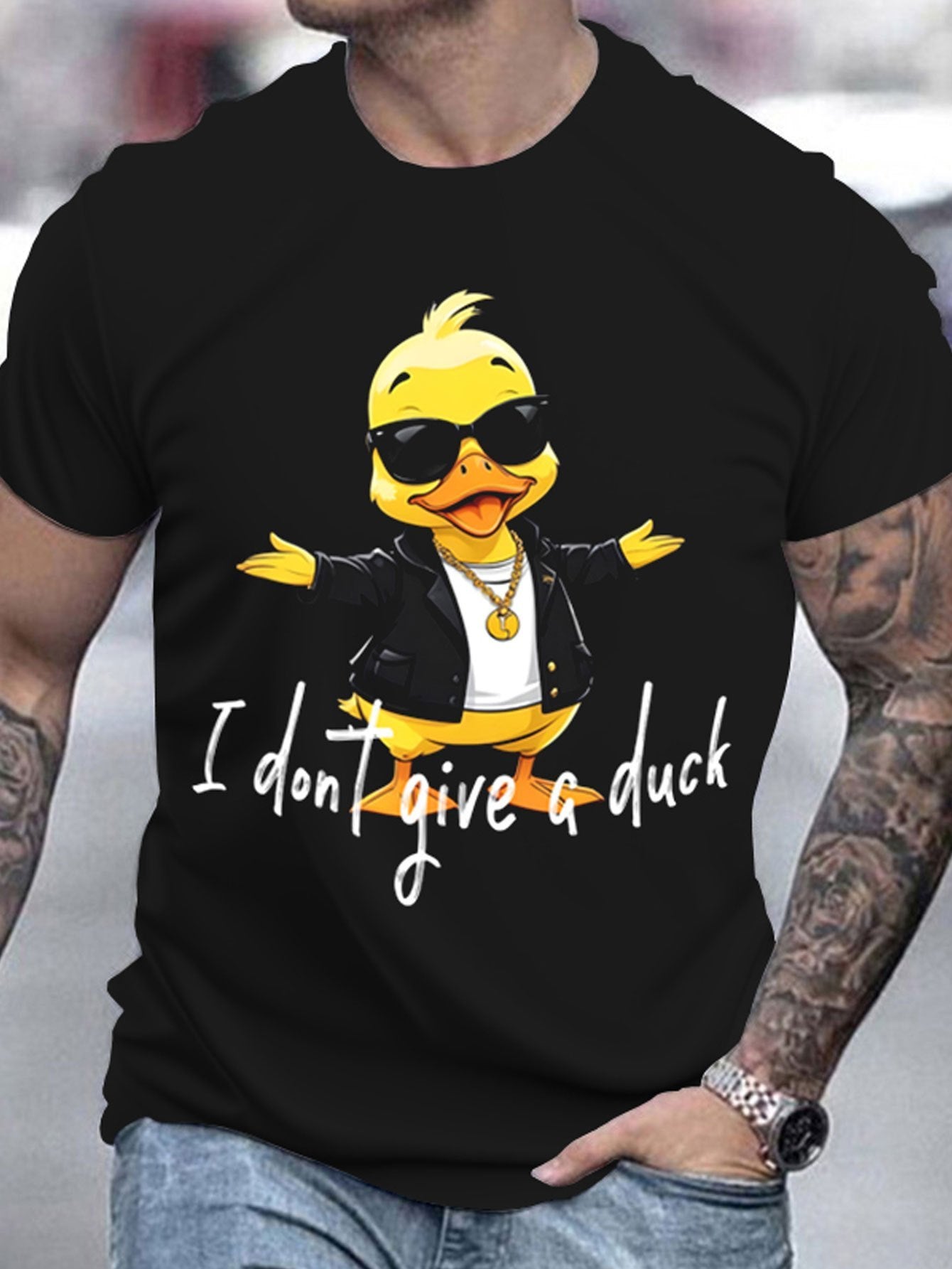 Black t-shirt with a cartoon duck wearing sunglasses and a jacket, text 'I don't give a duck', worn by a person.